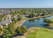 Thumbnail 9 of 11 - an aerial view of a neighborhood with a body of water