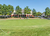Thumbnail 10 of 11 - a golf course with a building in the background