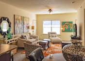 Thumbnail 16 of 21 - A living room with a brown leather chair and a brown leather ottoman.