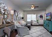 Thumbnail 4 of 13 - A living room with a grey patterned chair in the center.