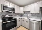 Thumbnail 3 of 18 - Kitchen with stainless steel appliances and shaker-style cabinets
