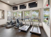 Thumbnail 19 of 27 - Gym with cardio machines and televisions