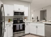 Thumbnail 2 of 27 - Kitchen with stainless steel appliances and shaker-style cabinets