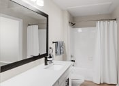 Thumbnail 6 of 27 - Renovated bathroom with White Cabinets