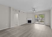 Thumbnail 3 of 27 - an empty living room with a fireplace and a ceiling fan