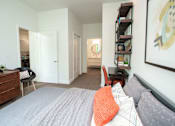 Thumbnail 6 of 14 - A bedroom with a bed, a chair, a dresser, and a painting on the wall.