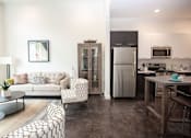 Thumbnail 10 of 14 - A modern kitchen with a refrigerator, microwave, and oven.