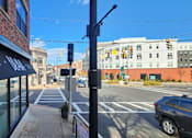 Thumbnail 8 of 14 - A street view with a black awning that says "DAVE'S" on it.