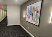 Thumbnail 17 of 36 - Fourth floor hallway with modern lighting fixtures at 68 Beale Apartments, Massachusetts
