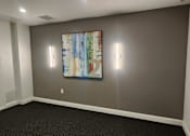 Thumbnail 18 of 36 - Modern room with abstract painting and wall lighting at 68 Beale Apartments, Quincy, MA 02169
