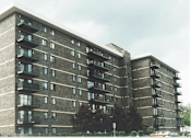 Thumbnail 12 of 12 - A large concrete building with balconies on each floor.