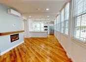 Thumbnail 93 of 96 - A room with wooden floors and a fireplace.