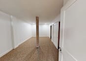 Thumbnail 86 of 96 - A long hallway with a carpeted floor and white walls.