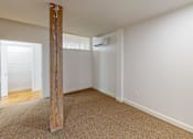 Thumbnail 78 of 96 - A room with a carpeted floor and a wooden pillar.