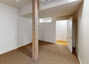 Thumbnail 76 of 96 - A room with a carpeted floor and a wooden pillar.