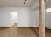 Thumbnail 77 of 96 - A room with a carpeted floor and a wooden pillar.