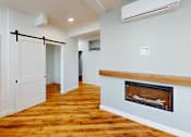 Thumbnail 84 of 96 - A room with a fireplace and a wooden floor.