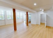 Thumbnail 45 of 96 - A room with wooden floors and white walls.