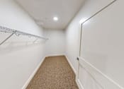 Thumbnail 60 of 96 - A white hallway with a metal rack on the wall.