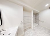 Thumbnail 50 of 96 - A white bathroom with a toilet, sink, and shower.