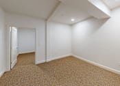 Thumbnail 44 of 96 - A room with white walls and carpeted floor.