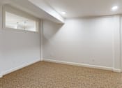 Thumbnail 57 of 96 - A room with a carpeted floor and a door.
