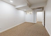 Thumbnail 65 of 96 - A room with carpeted floor and white walls.
