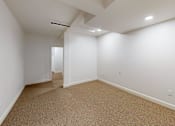 Thumbnail 66 of 96 - A room with carpeted floor and white walls.