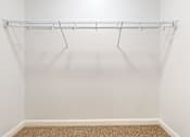 Thumbnail 68 of 96 - Empty white closet with a metal rack.