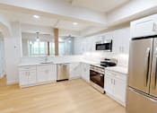 Thumbnail 33 of 96 - A modern kitchen with wooden floors and stainless steel appliances.