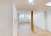 Thumbnail 43 of 96 - A long hallway with a wooden pillar in the middle.