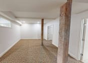 Thumbnail 26 of 96 - A room with a carpeted floor and white walls.