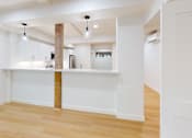 Thumbnail 34 of 96 - A kitchen with white cabinets and a wooden beam.