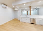 Thumbnail 27 of 96 - A kitchen with white cabinets and a wooden floor.