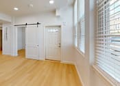 Thumbnail 24 of 96 - A room with a wooden floor and white walls.