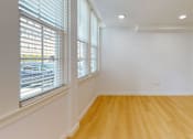 Thumbnail 28 of 96 - A room with wooden floors and white walls.