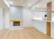 Thumbnail 32 of 96 - A room with a fireplace and wooden floors.
