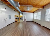 Thumbnail 5 of 12 - A room with wooden floors and a white door.