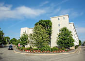 Thumbnail 9 of 12 - A large white building with a red stop sign in front of it.