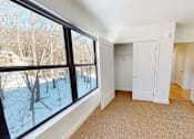 Thumbnail 41 of 53 - A room with a large window showing a snowy landscape outside.