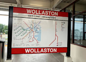 Thumbnail 29 of 36 - Wollaston station sign with red line transit map at 68 Beale Apartments, Quincy