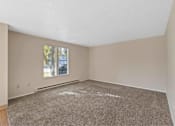 Thumbnail 3 of 7 - A room with a carpeted floor and a window.
