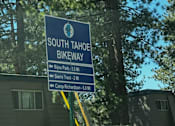 Thumbnail 12 of 18 - A sign for the South Tahoe Bikeway is shown in front of a building.