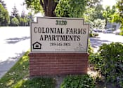Thumbnail 1 of 19 - Colonial Farms Apartments - address sign with phone number 209-545-3925 and TTY 711
