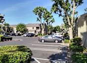 Thumbnail 8 of 19 - Colonial Farms Apartments - view of parking lot with apartment buildings in the background