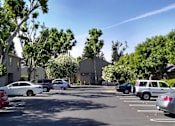 Thumbnail 6 of 19 - Colonial Farms Apartments - view of parking lot with apartment buildings in the background