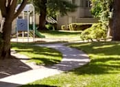 Thumbnail 3 of 19 - Colonial Farms Apartments - concrete walkway with grass and trees on either side