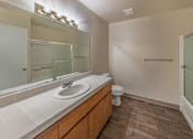 Thumbnail 15 of 18 - A bathroom with a sink, toilet, and a mirror.