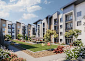 Thumbnail 5 of 6 - A row of modern apartment buildings with a well-maintained garden in the foreground.