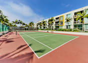 Thumbnail 21 of 24 - A tennis court is surrounded by a green fence and palm trees at Marina Harbor, California, 90292